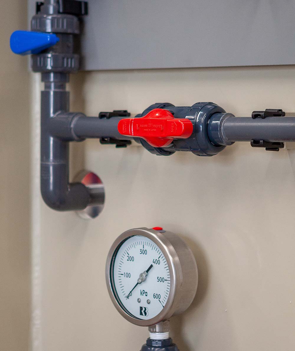 Image of a piping system mounted to a wall using pipe clips