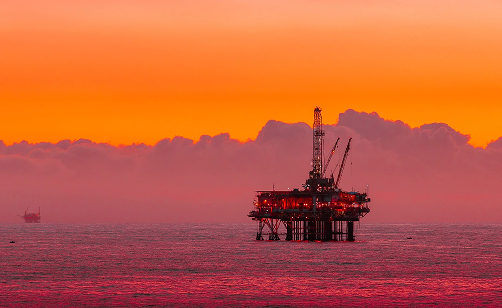 An oil rig in the sunset