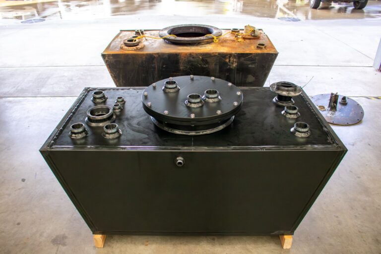 photo of the original and new sewage tanks in a workshop